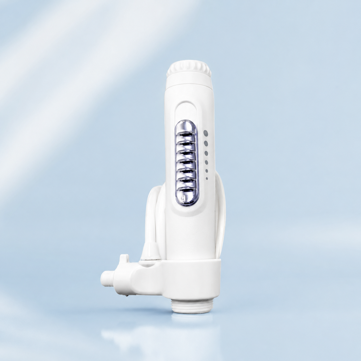 Bloc moteur blanc NEOPULSE pour jet dentaire NP1 avec sélecteur de pression sur fond bleu clair